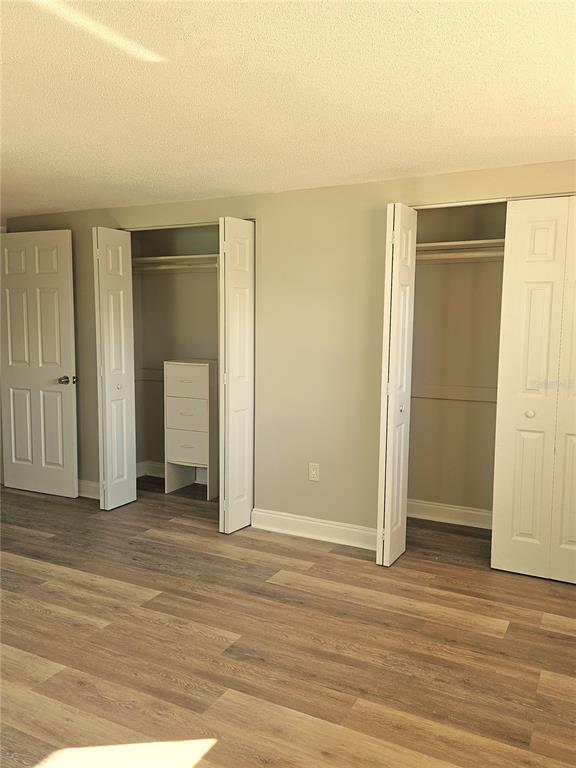 7821 Lotus Drive Port Richey, FL 34668 - Photo 13 of 19 an empty room with wooden floor and closet