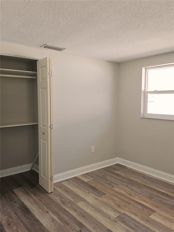 7821 Lotus Drive Port Richey, FL 34668 - Photo 14 of 19 an empty room with wooden floor and windows