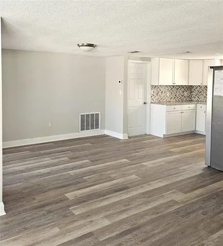 a view of kitchen and empty room