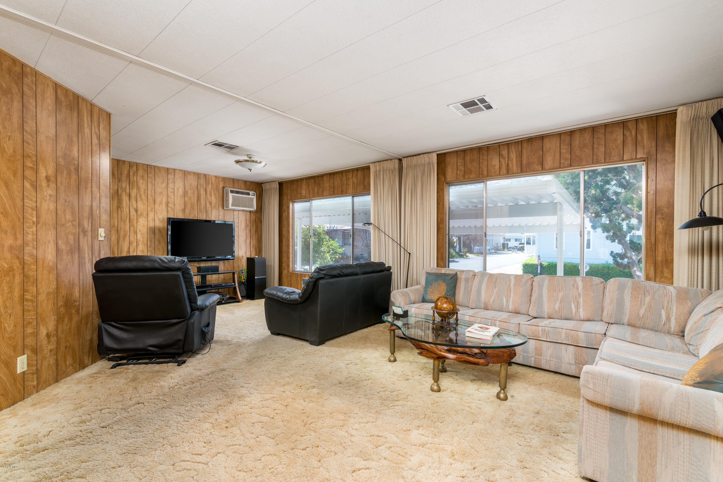 6480 Katherine Street, Unit 16 Simi Valley, CA 93063 - Photo 2 of 24 a living room with furniture and a flat screen tv
