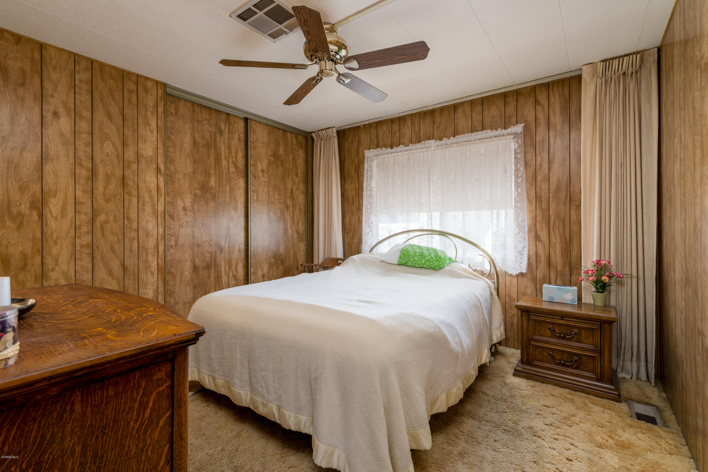 6480 Katherine Street, Unit 16 Simi Valley, CA 93063 - Photo 13 of 24 a bedroom with a bed and a table