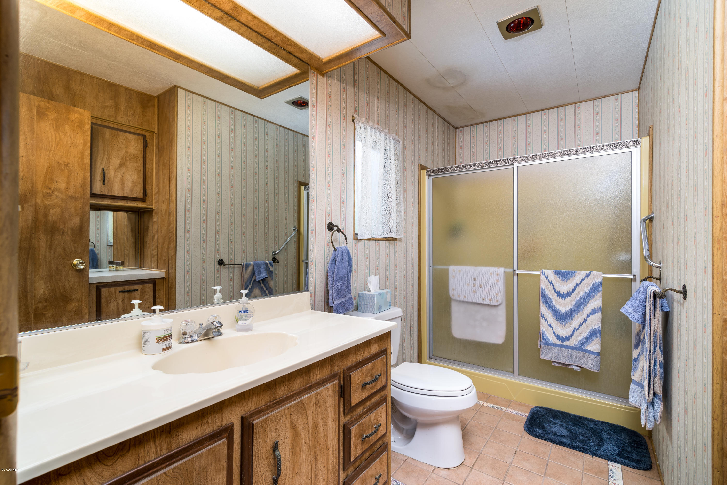 6480 Katherine Street, Unit 16 Simi Valley, CA 93063 - Photo 16 of 24 a bathroom with a sink a toilet and shower