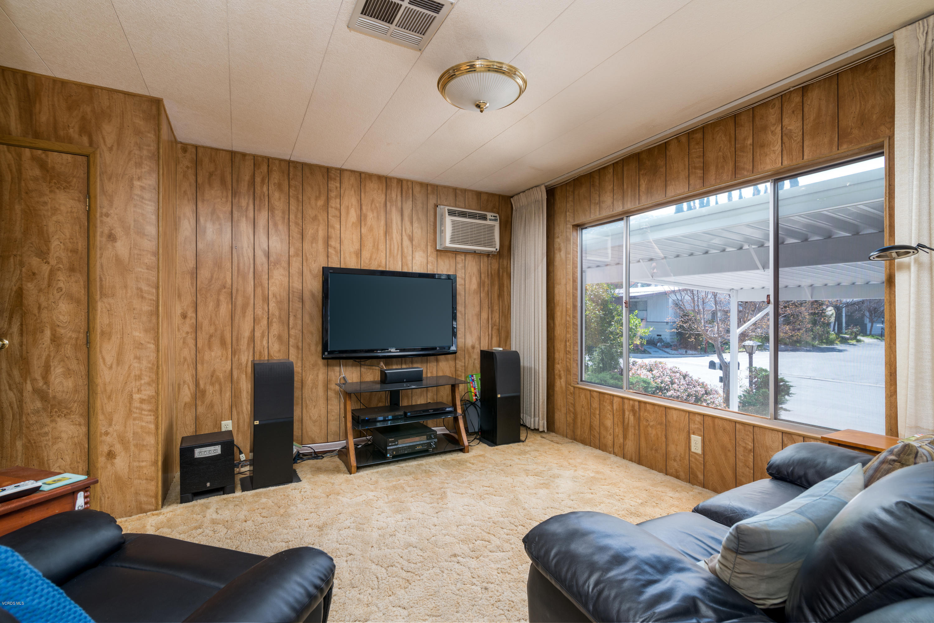 6480 Katherine Street, Unit 16 Simi Valley, CA 93063 - Photo 7 of 24 a living room with furniture and a flat screen tv