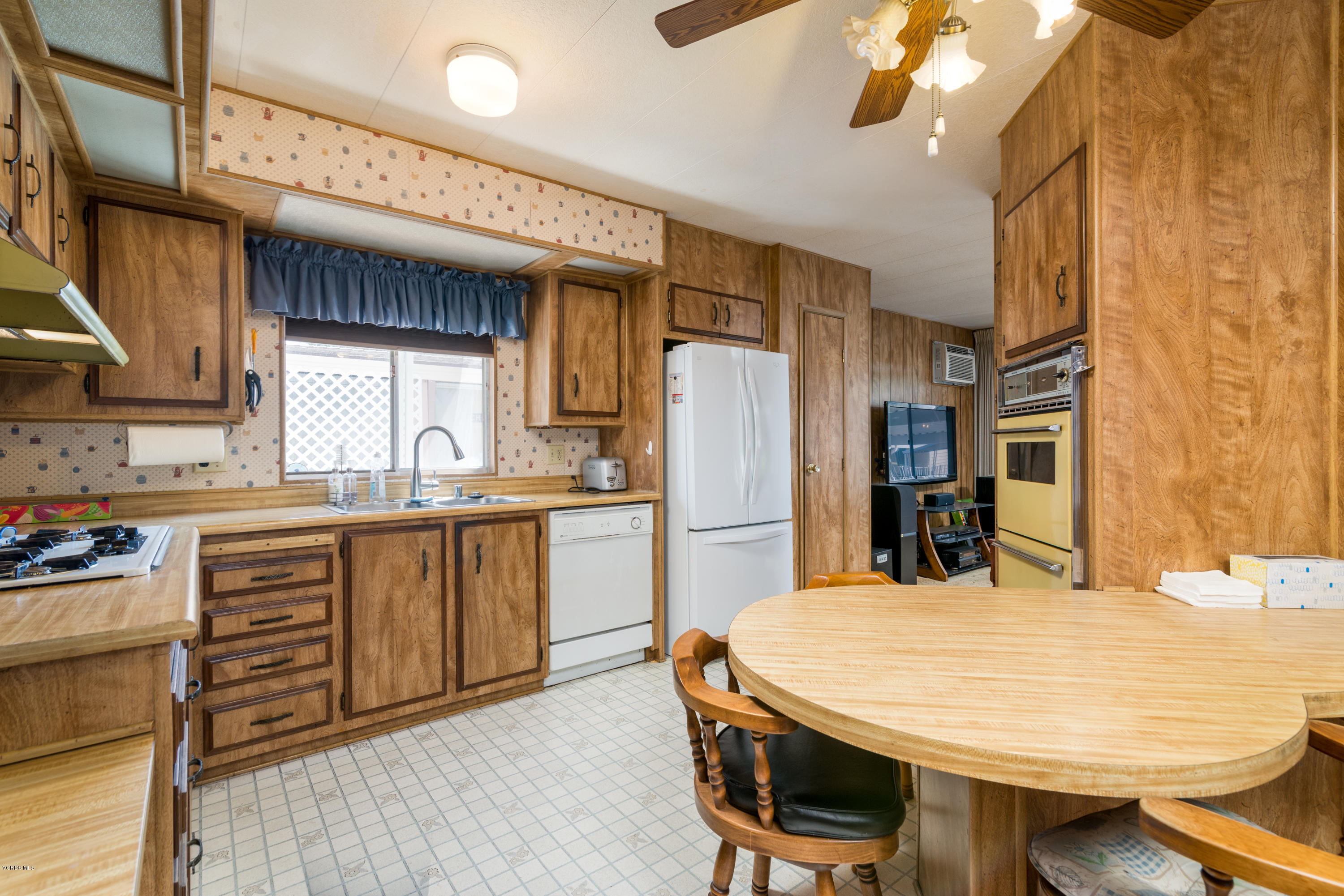 6480 Katherine Street, Unit 16 Simi Valley, CA 93063 - Photo 9 of 24 a kitchen with refrigerator and cabinets
