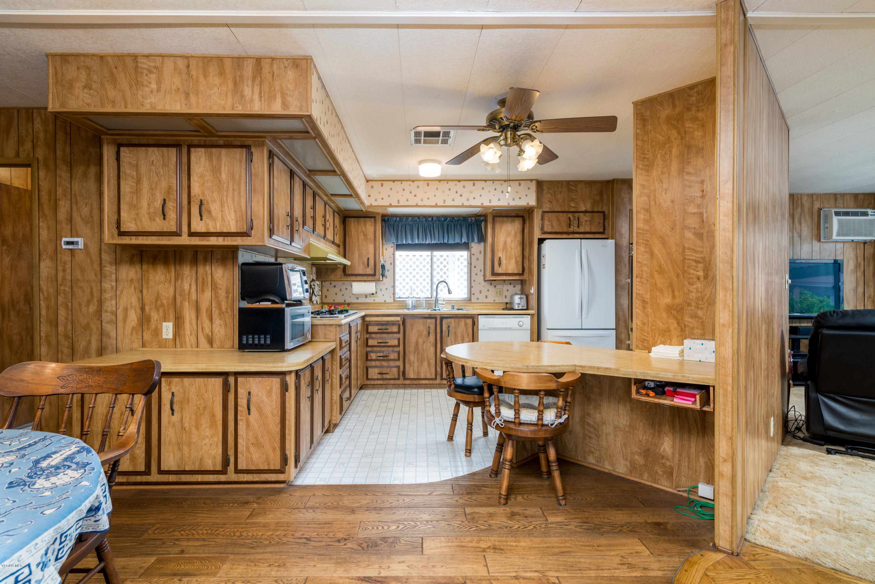 6480 Katherine Street, Unit 16 Simi Valley, CA 93063 - Photo 10 of 24 a view of a living room and kitchen with furniture