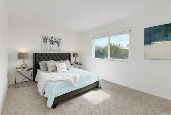 a bedroom with a bed and window