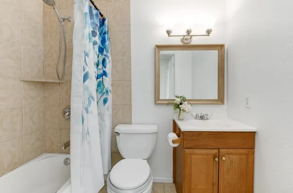 a bathroom with a toilet a sink and a mirror