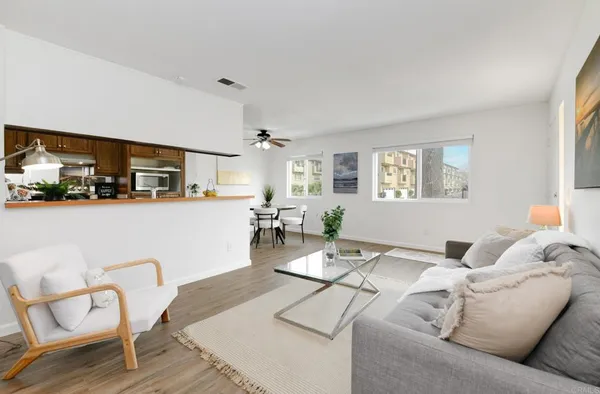 a living room with furniture and kitchen view