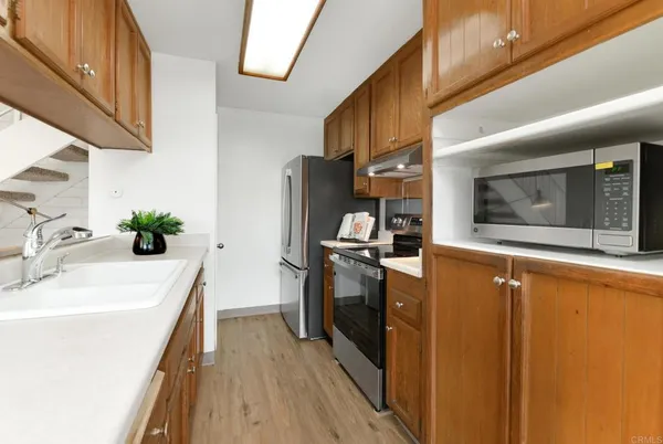 a kitchen with stainless steel appliances a microwave a stove and a refrigerator
