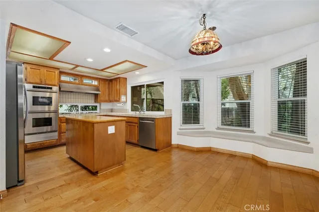 a kitchen with stainless steel appliances granite countertop a stove and a refrigerator