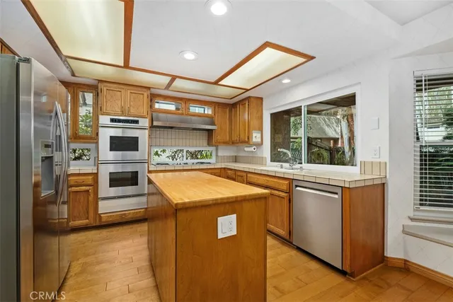 a kitchen with a stove a sink and a refrigerator