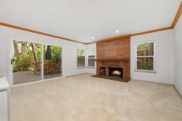a view of fireplace with an empty room