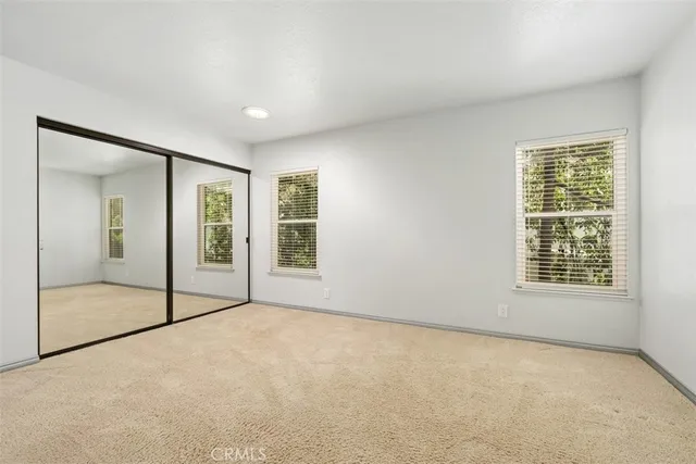 an empty room with a exposed radiator down to a window
