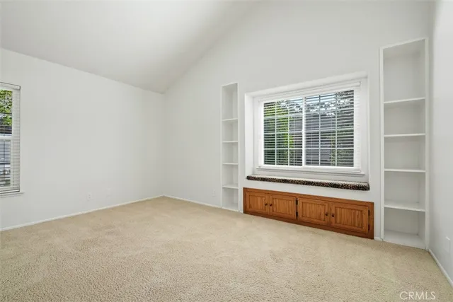 a bathroom with a double vanity sink and mirror with toilet