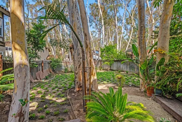 a backyard of a house with lots of green space and lake view