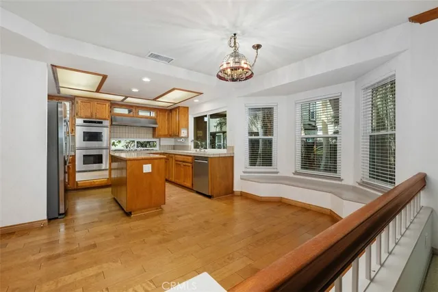 a kitchen with stainless steel appliances granite countertop a stove and a sink