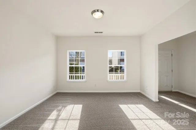 a view of an empty room with windows
