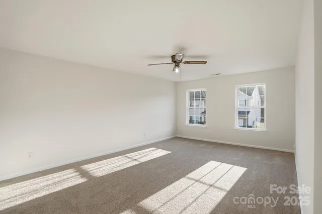 a view of a livingroom with a window and a ceiling fan