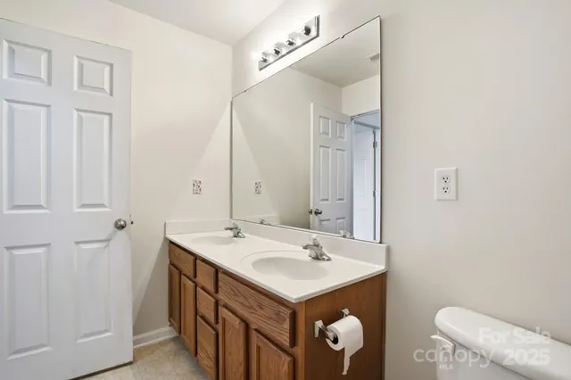 a bathroom with a toilet and a shower curtain