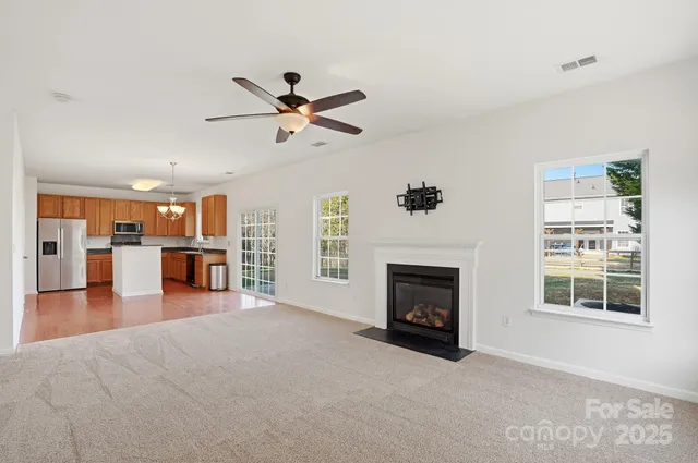 a view of a livingroom with a fireplace and window