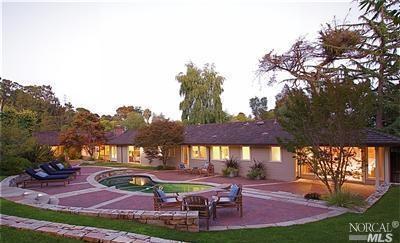 175 Montecito Road San Rafael, CA 94901 - Photo 1 of 1 a patio with tables and chairs and a fire pit