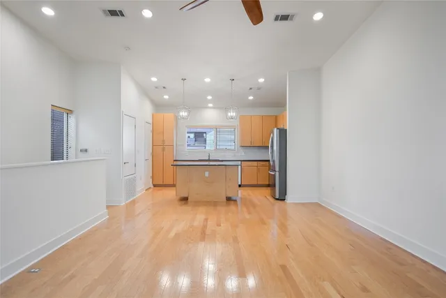 a view of kitchen with kitchen island microwave and sink