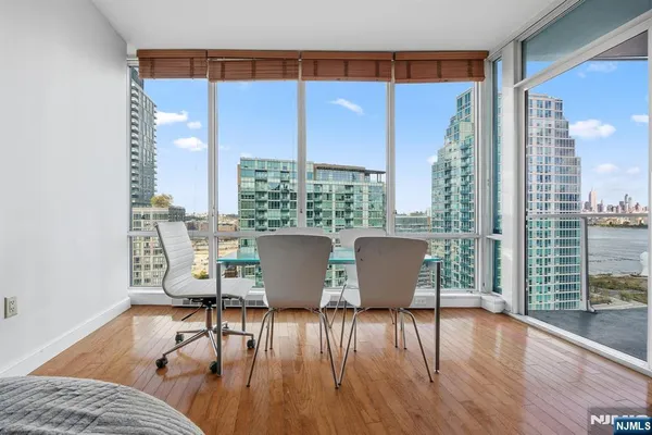 a view of a dining room with furniture window and wooden floor