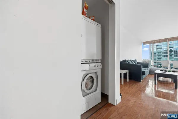 a kitchen with stainless steel appliances granite countertop a sink refrigerator and cabinets