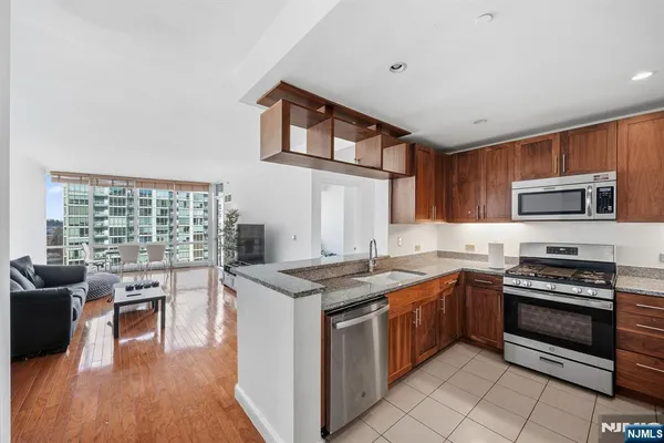 a bedroom with a bed a table and wooden floor