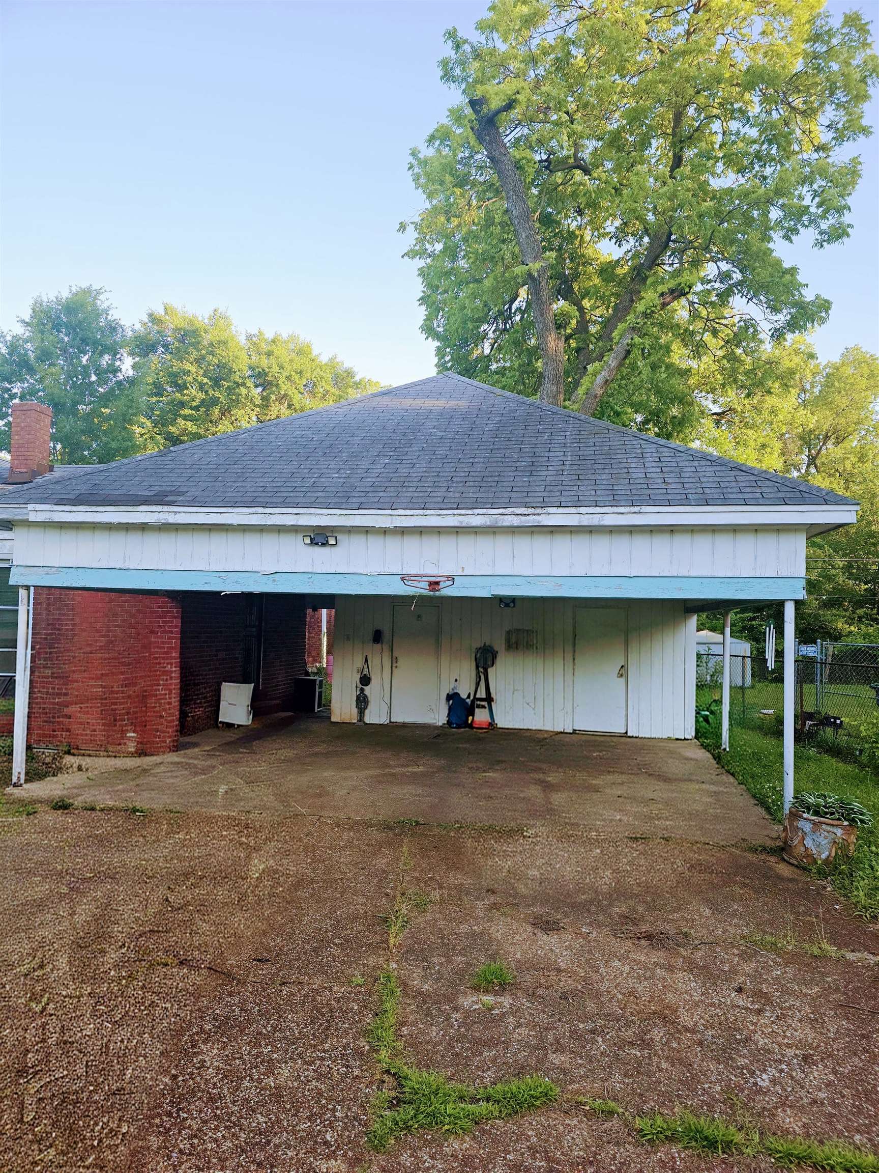 1515 Semmes Street Memphis, TN 38114 - Photo 6 of 9 Attached carport with a gabled roof and concrete flooring