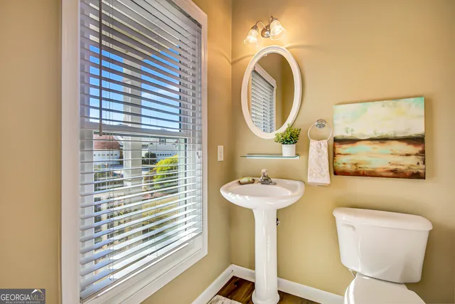 a bathroom with a toilet sink and mirror
