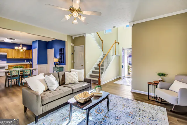a living room with furniture and wooden floor