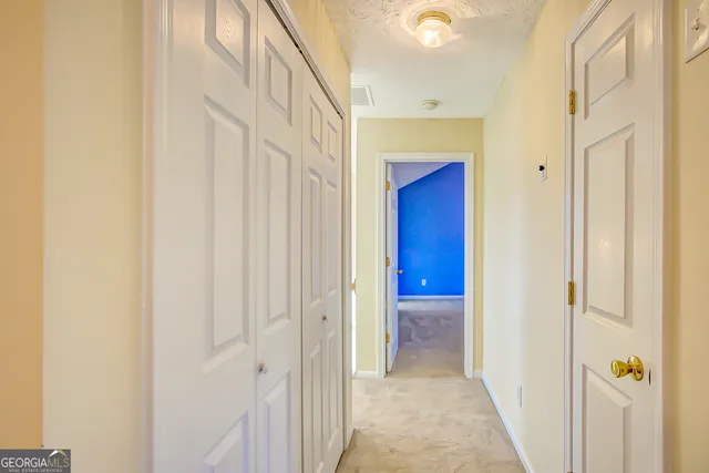a view of a hallway with wooden shelves