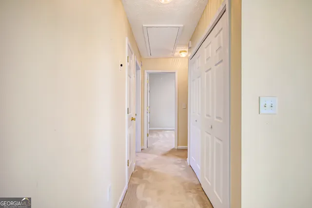 a view of a hallway with a white walls