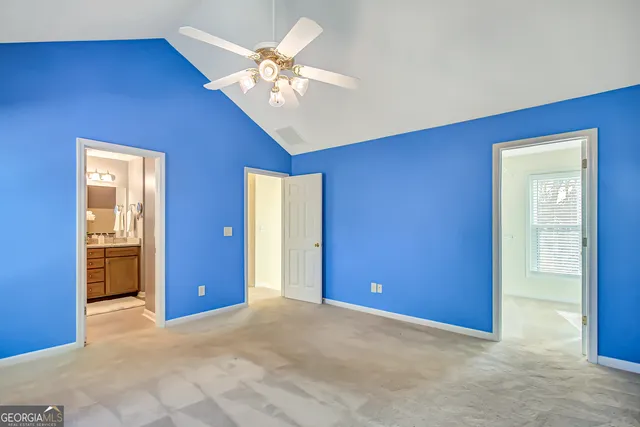 an empty room with chandelier fan