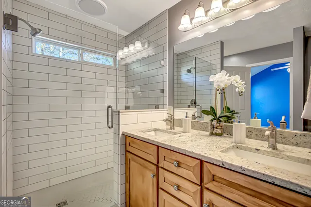 a bathroom with a granite countertop sink and a mirror
