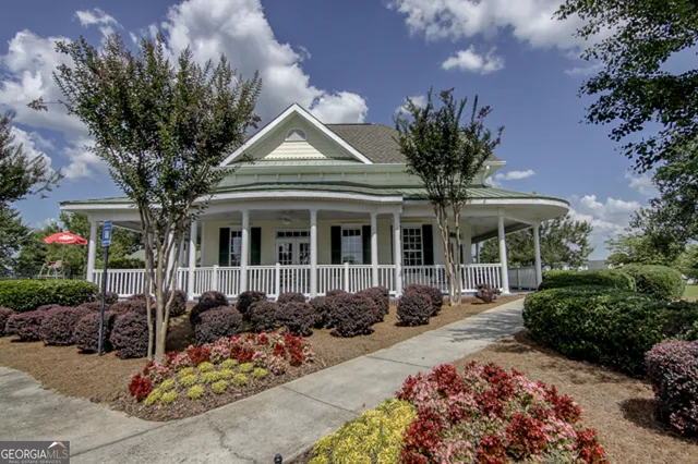 a front view of a house with lots of potted plants