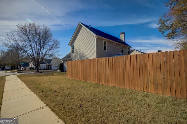 a view of a backyard with a large tree