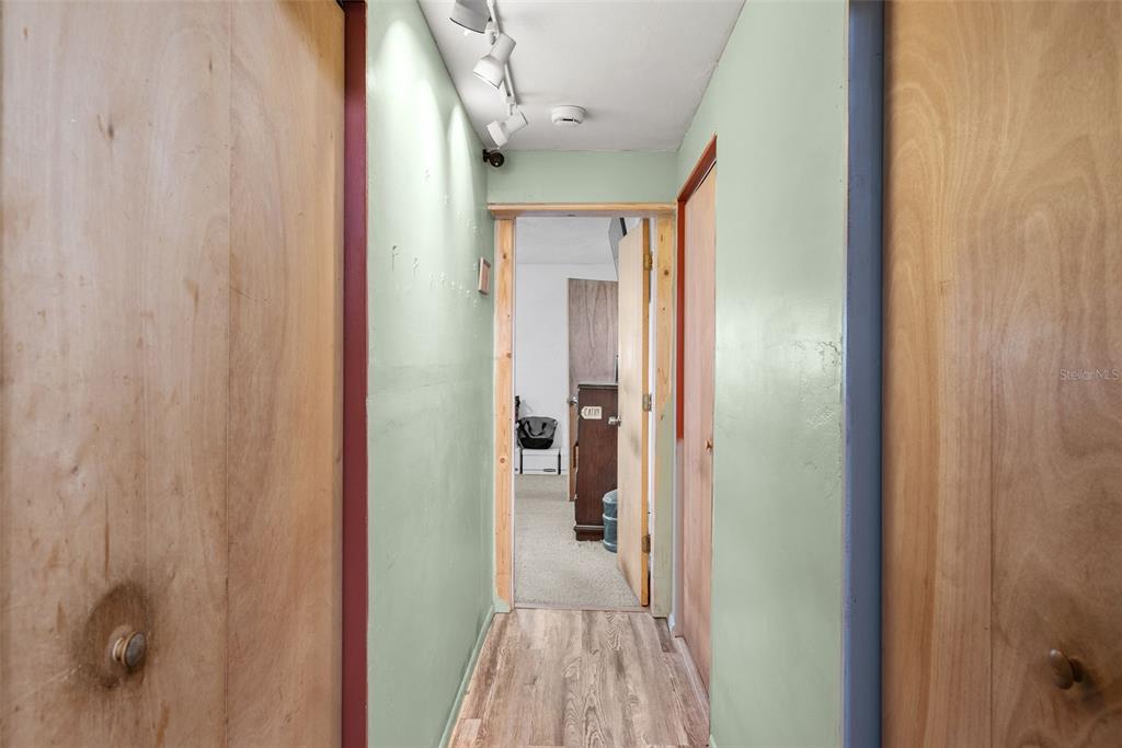 4245 Crestfield Avenue Holiday, FL 34691 - Photo 11 of 28 a view of a hallway with wooden floor and staircase
