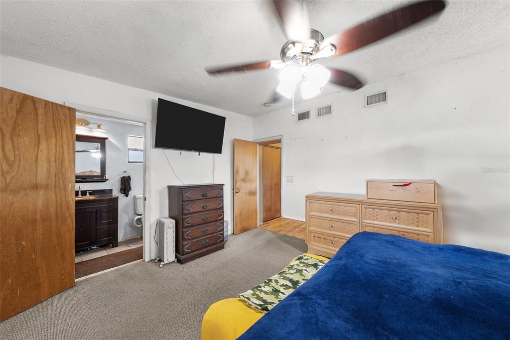 4245 Crestfield Avenue Holiday, FL 34691 - Photo 13 of 28 a bedroom with furniture and a flat screen tv