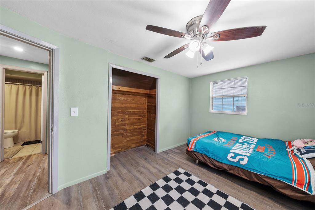 4245 Crestfield Avenue Holiday, FL 34691 - Photo 18 of 28 a bedroom with a bed and wooden floor