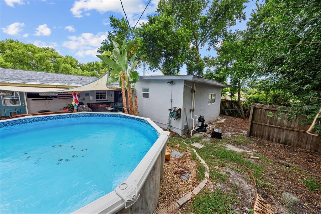 4245 Crestfield Avenue Holiday, FL 34691 - Photo 26 of 28 a view of a patio with table and chairs and wooden fence
