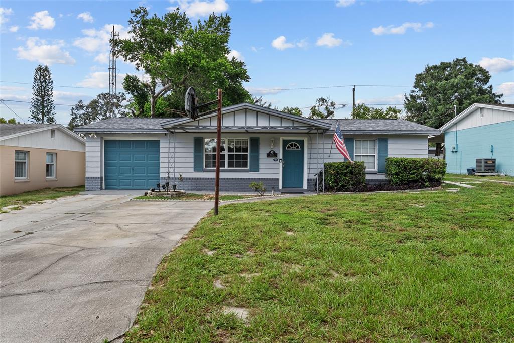4245 Crestfield Avenue Holiday, FL 34691 - Photo 27 of 28 a front view of a house with yard and green space