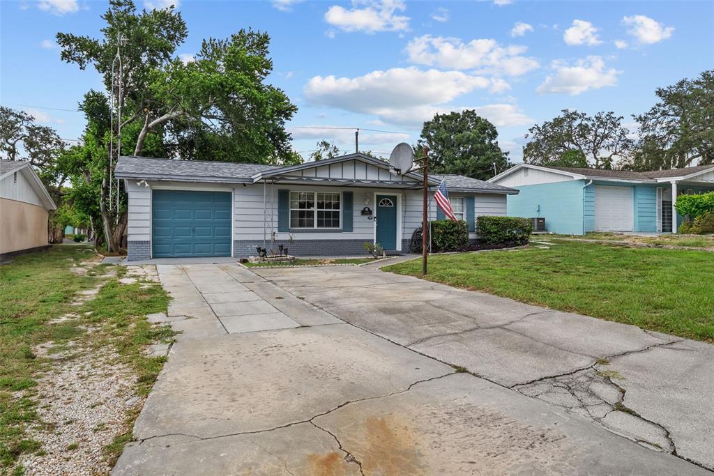4245 Crestfield Avenue Holiday, FL 34691 - Photo 28 of 28 a front view of house with yard and green space
