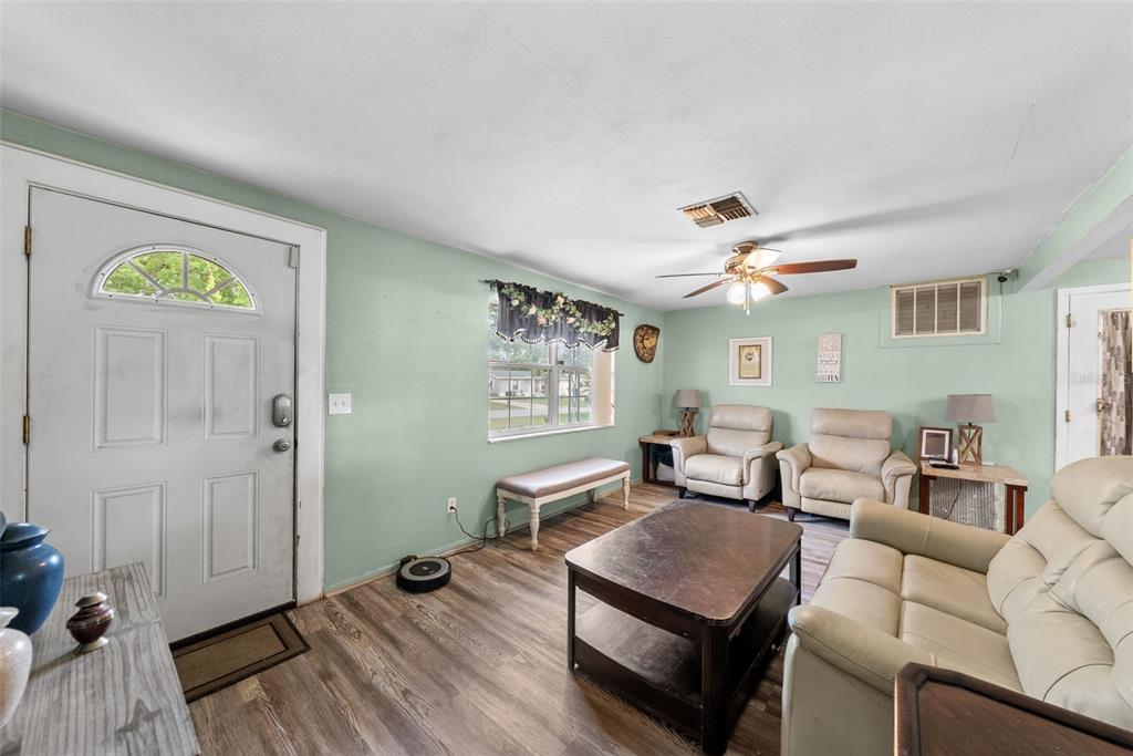 4245 Crestfield Avenue Holiday, FL 34691 - Photo 5 of 28 a living room with furniture and a wooden floor