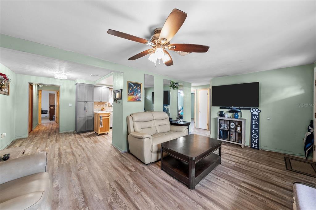 4245 Crestfield Avenue Holiday, FL 34691 - Photo 6 of 28 a living room with furniture and a flat screen tv