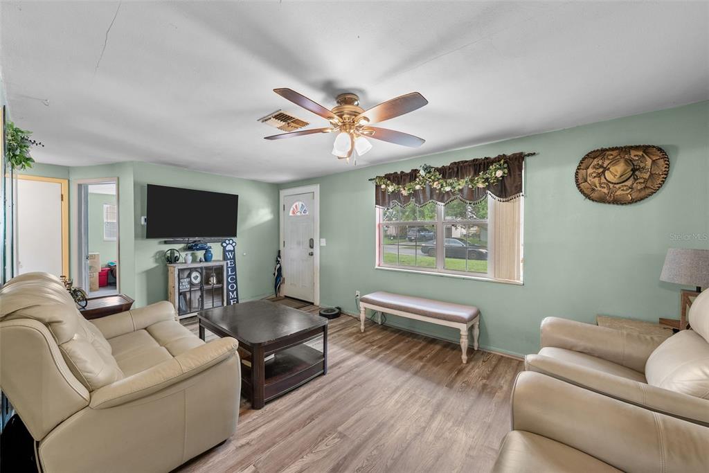 4245 Crestfield Avenue Holiday, FL 34691 - Photo 7 of 28 a living room with furniture and a flat screen tv