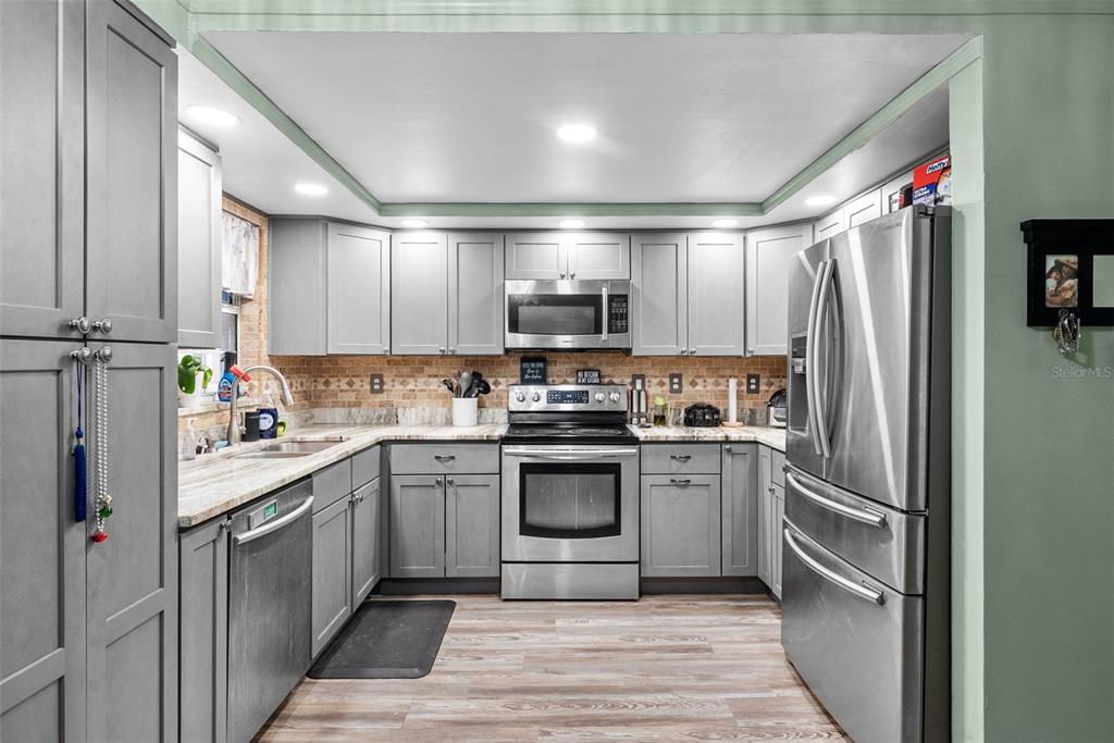 4245 Crestfield Avenue Holiday, FL 34691 - Photo 10 of 28 a kitchen with a sink stainless steel appliances and cabinets