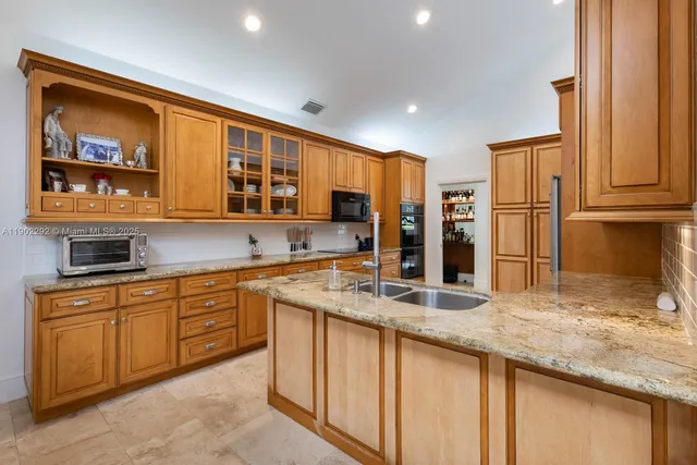 a kitchen with stainless steel appliances granite countertop a sink and cabinets