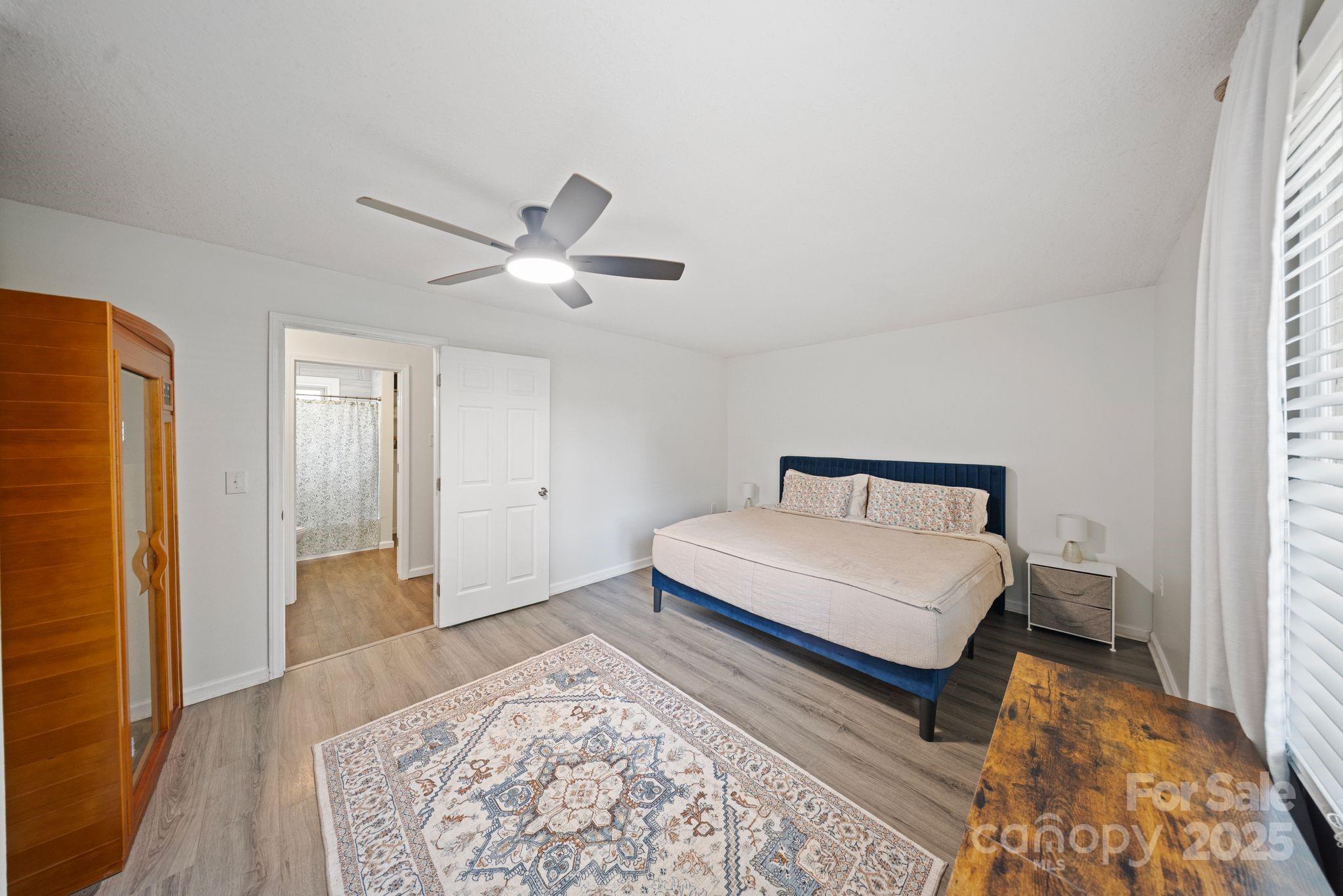 5703 Valley Field Road Southeast Hickory, NC 28602 - Photo 15 of 33 a bedroom with a bed and a dresser with wooden floor